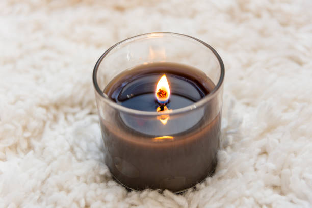 istock Black candle burning on white textured background with room for copy 917091098