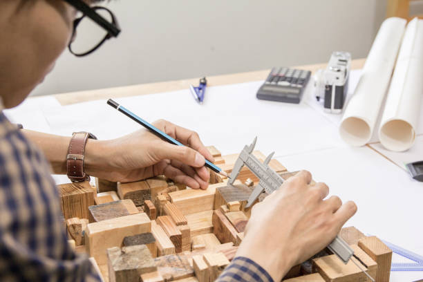 istock Concept architects,engineer holding pen pointing equipment architects On the desk with a blueprint in the office, Vintage, Sunset light.Selective Focus 917091204