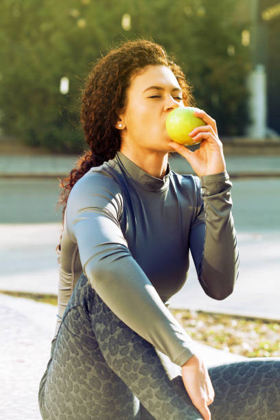 istock Sportswoman eating an apple 917094128