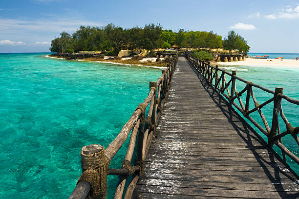 istock Rustic wooden prison island bridge on clear blue ocean water 91709649