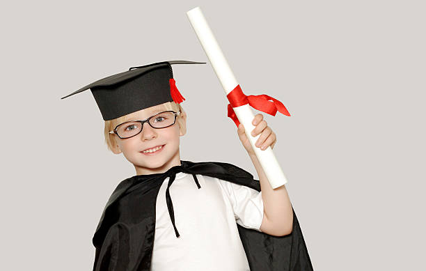 istock schoolboy in graduation cap isolated 91709989