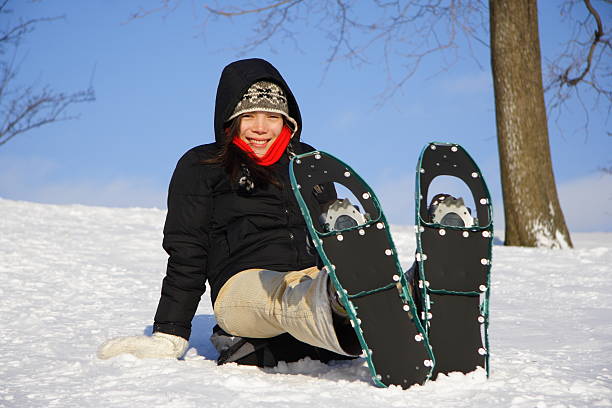 junge frau wandern mit schneeschuhen - snowshoeing snowshoe women shoe stock-fotos und bilder