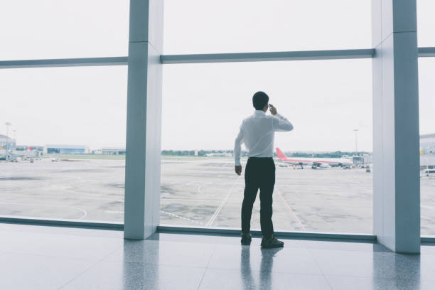 istock Businessman using phone at airport 917101934