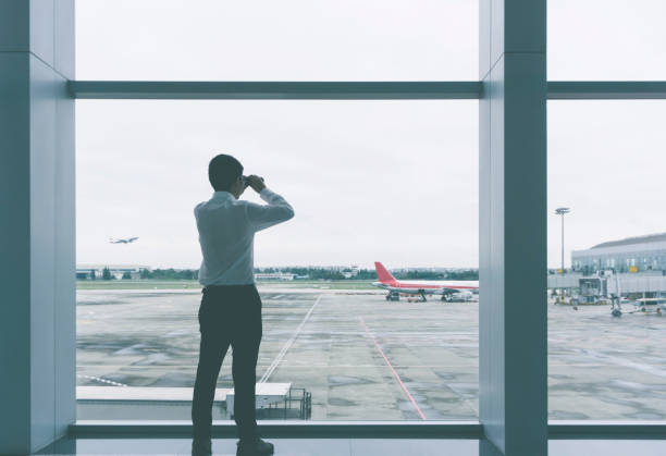 istock Businessman looking with binoculars at airport 917102086