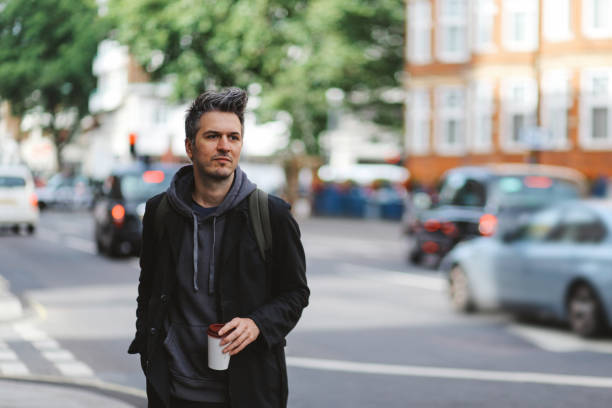 istock Young man having a coffee on the go, in London, UK 917107244