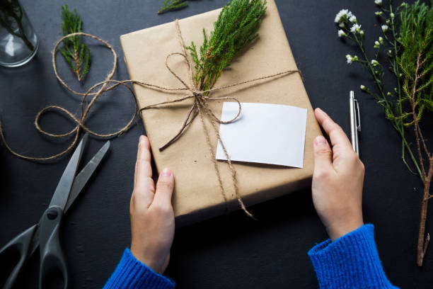 Wrapping present for celebration and having card on the desk stock photo