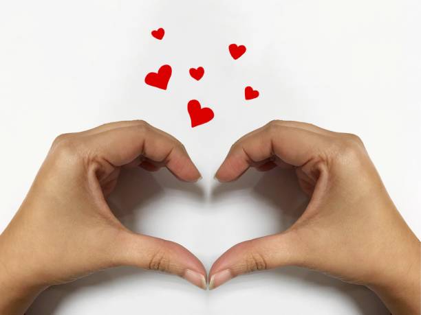 istock Woman hand make heart shape and red hearts 917116422