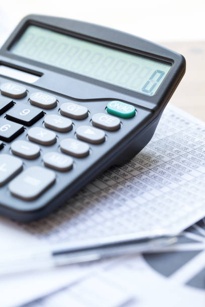 istock Pen, calculator and statistical data paper, business finance concept 917122406