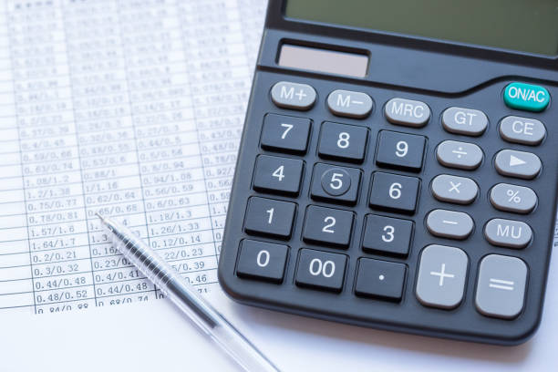 istock Pen, calculator and statistical data paper, business finance concept 917122546