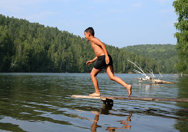 istock happy asian boy diving in lake 91712491