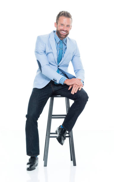 istock Handsome businessman seated on stool 917125668