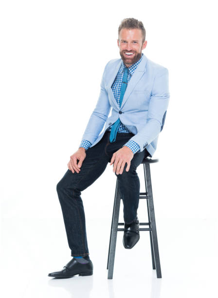 istock Handsome businessman seated on stool 917125670