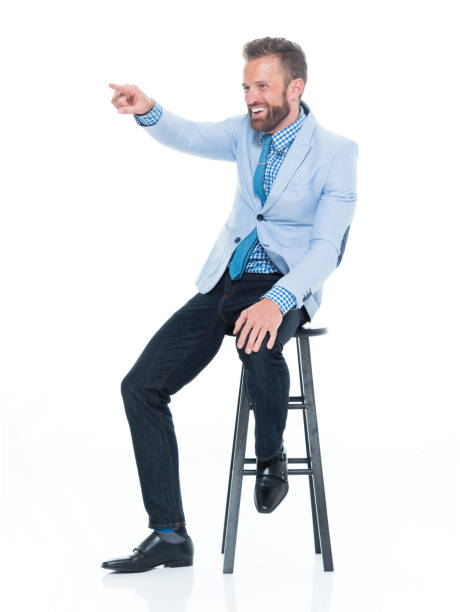 istock Handsome businessman seated on stool 917125698
