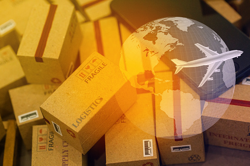 grouping Light brown small boxes and cell phone with a plane flies above world map. For ideas about transportation, international freight, global shipping, overseas trade, regional ,local forwarding.