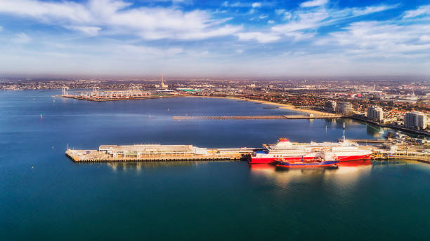 D Me Port Tas Ferry bay Melbourne's Port Phillip Bay with car moving ferry to Tasmania docked at the passenger terminal and cargo wharf on a sunny bright day under blue sky. south yarra stock pictures, royalty-free photos & images