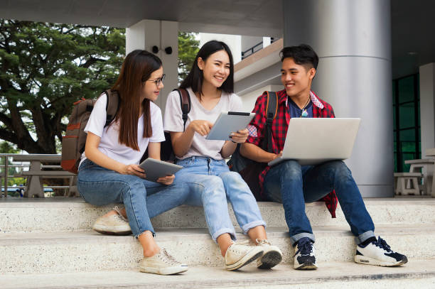 istock Group of young asian studying in university sitting during lecture education students college university studying youth campus friendship teenager teens concept. 917136524