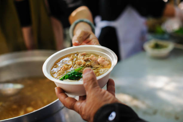 istock Feeding the poor to hands of a beggar. Poverty concept 917138762
