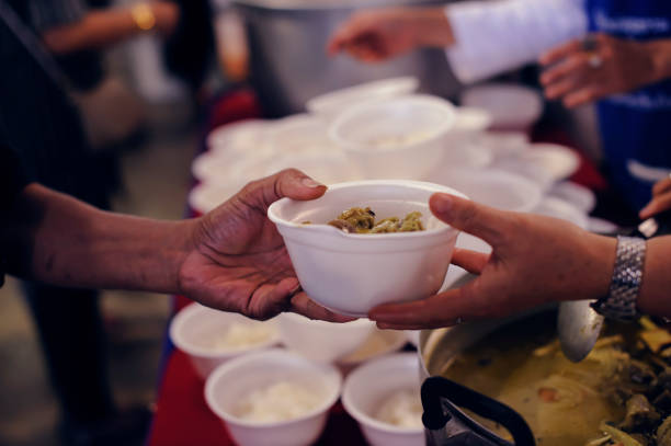 istock Feeding the poor to hands of a beggar. Poverty concept 917138830