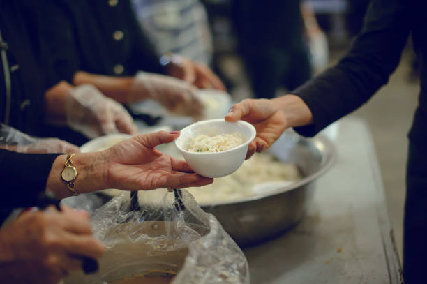 istock Feeding the poor to hands of a beggar. Poverty concept 917138988