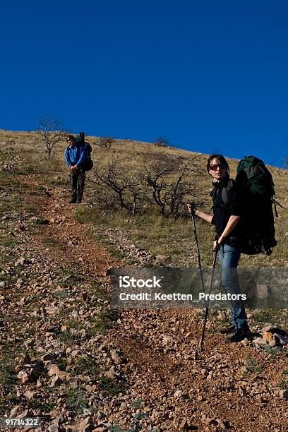 Two Hikers Climbing Up The Mountain Stock Photo - Download Image Now - Active Lifestyle, Adult, Adventure