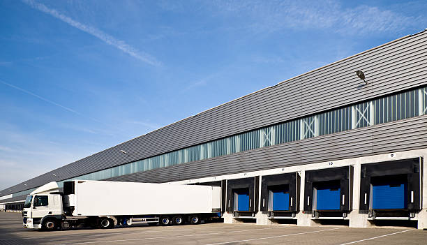 istock White semi truck backing into a row of loading docks 91714765