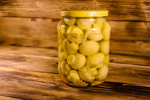 istock Jar with canned mushrooms on wooden table 917153250