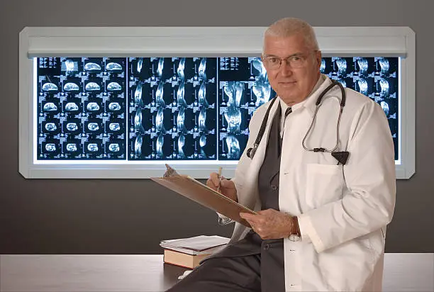 Photo of Doctors looks at medical notes against an X-ray background