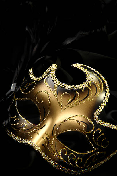 Gold carnival mask against black background