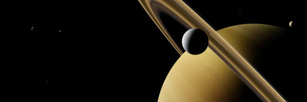istock planet Saturn with moon Enceladus and other moons 917159718