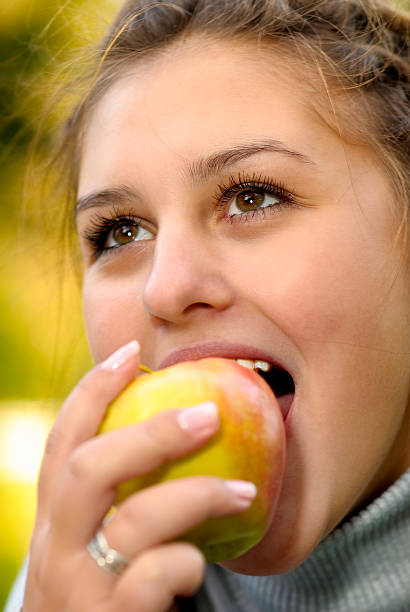 istock Girl with an apple 91716016