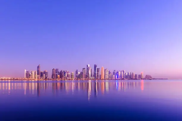 Futuristic Modern Skyline with Reflection in the Still Corniche Bay Waters, Last of the Sunlight Falling on the Buildings.