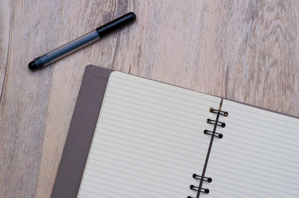 istock Pen and note pad, isolated on wooden texture 917163966