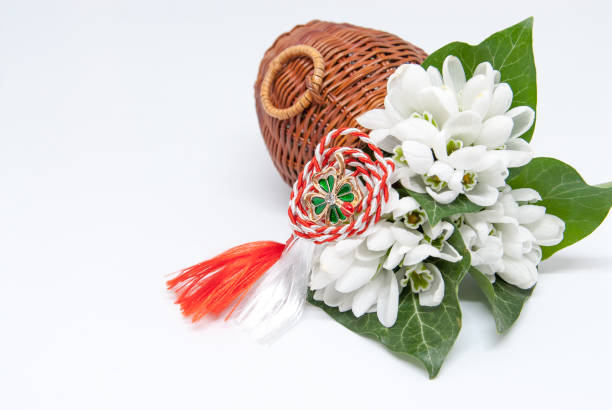 snowdrops and red and white string martisor on white with copy space east european first of march tradition celebration