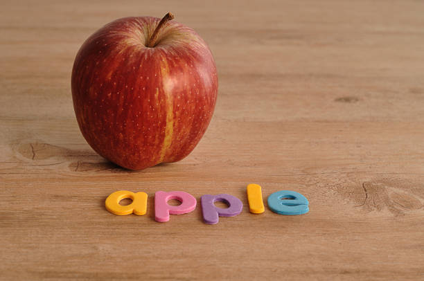 istock An apple with the word apple on a wooden background 917170030