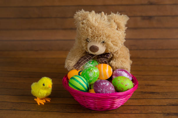 istock Easter colorful eggs, teddy bear and toy chicken 917170034