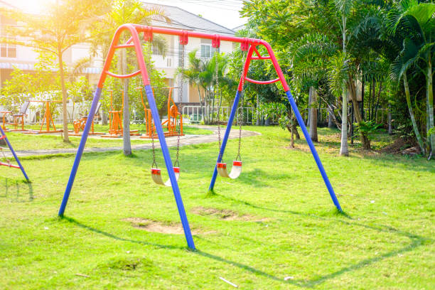 пустые качели на детской площадке - swing playground empty abandoned стоковые фото и изображения