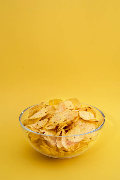 istock A plate of chips on a yellow background closeup 917176678