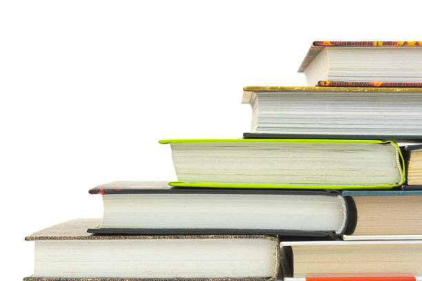 Old books stacked on a wooden table at the library.