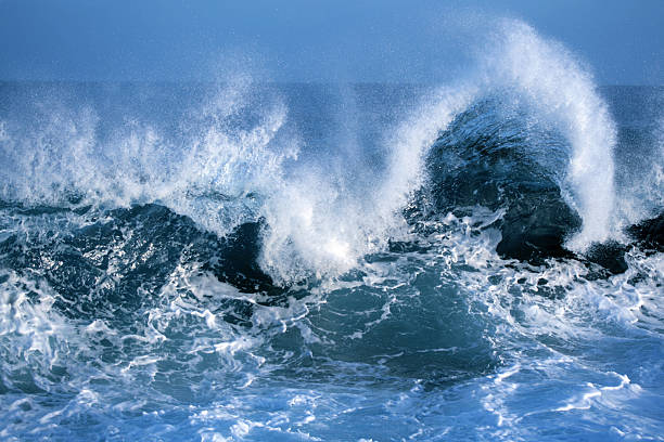 Close-up of blue ocean waves crashing against one another stock photo