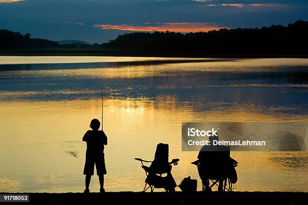 A Silhouette Of Two People Fishing At Sunrise Stock Photo - Download Image Now - Fishing, Pennsylvania, Backgrounds