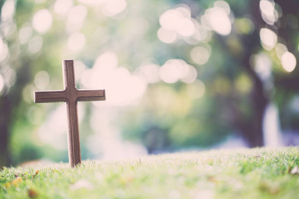 istock The cross standing on meadow sunset and bokeh background. 917180652