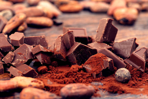 istock Dark chocolate, cocoa powder and coffee beans on a wooden table 917181194