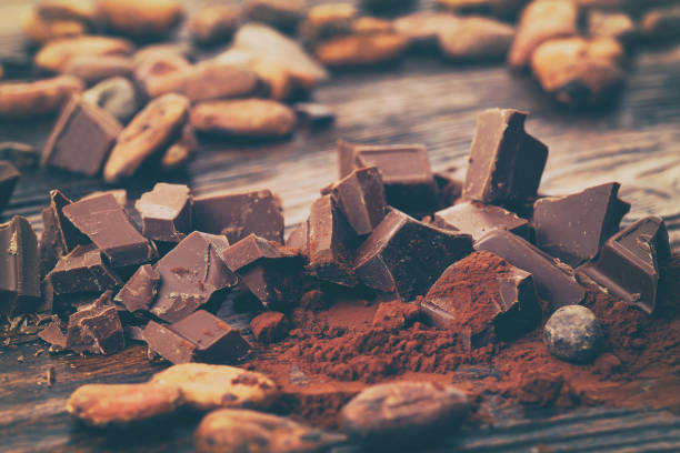 istock Dark chocolate, cocoa powder and coffee beans on a wooden table 917181250
