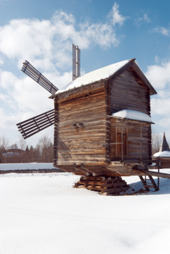 Wind mill  .winter rural landscape.Russian traditional architecture