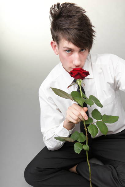istock Portrait young man and rose enamoured love 917184842