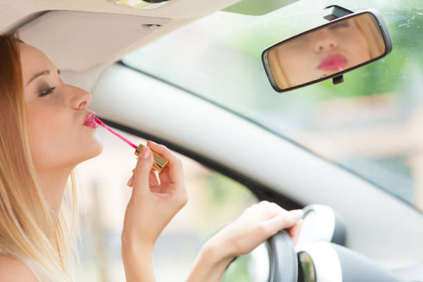 istock Woman applying makeup while driving her car 917185904