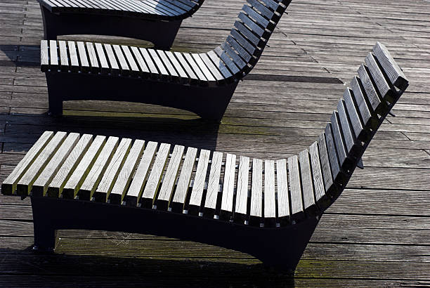 istock Wooden chairs on pier 91718638
