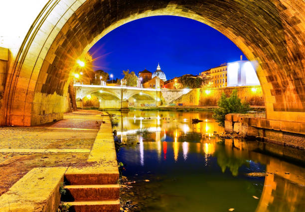 View of St. Peter's Basilica from Aelian Bridge in Rome at night.