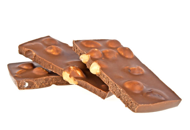 istock Milk chocolate bar with nuts on a white background, closeup 917188956
