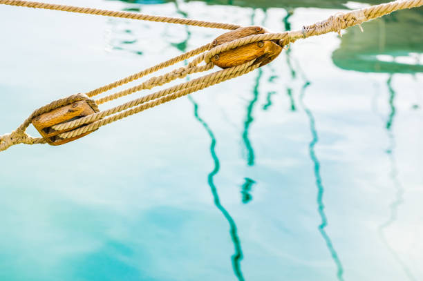 istock Pulley, block and tackle with moored nautical rope 917191770